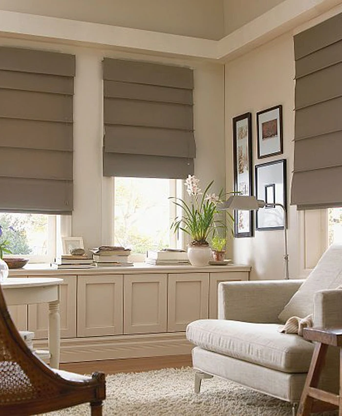 Tailored cascading Roman fabric blinds in elegant living space